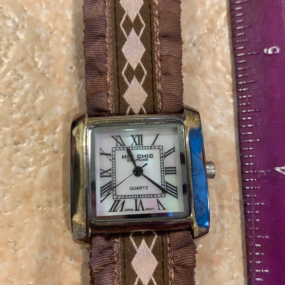Brown banded watch with snap closure